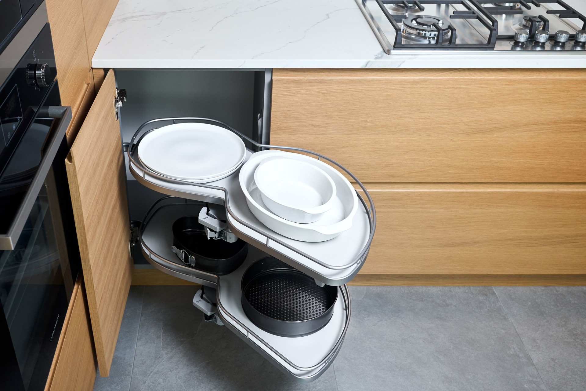 Kitchen access mechanism Magic corner for Blind Corner Cabinets. Solution for a kitchen corner storage in cupboard. Corner unit with pull out shelves for cookware.
